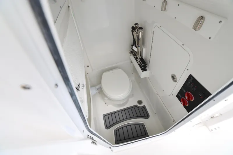 Slide: The Image of 2025 Sea Hunt Gamefish 27 Forward Seating boat interior with marine toilet. - 9