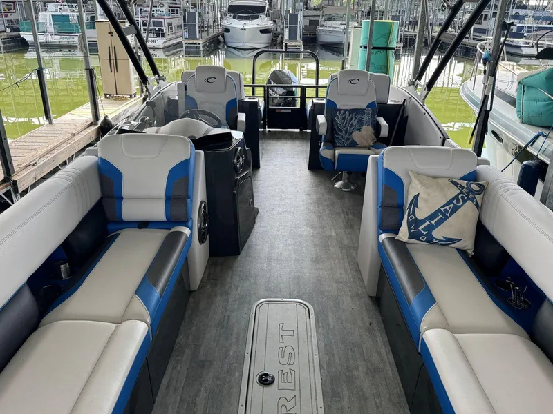 Slide: The Image of 2022 Crest Caribbean RS 250 SLRC pontoon boat interior with blue and white seating. - 13