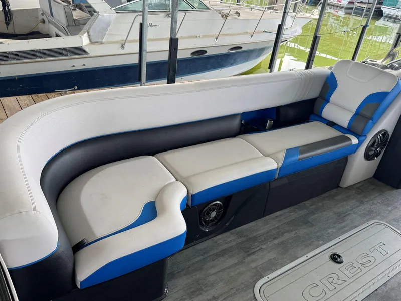 Slide: The Image of 2022 Crest Caribbean RS 250 SLRC boat interior with blue and white seating. - 15