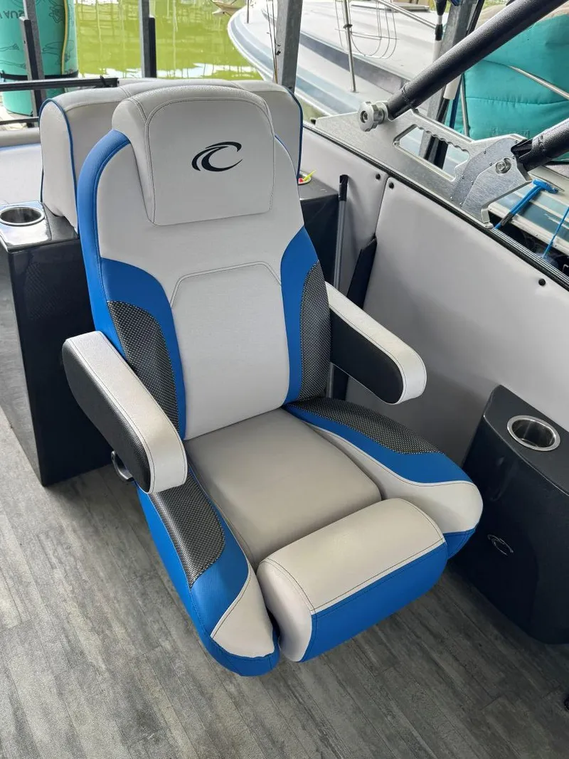 Slide: The Image of 2022 Crest Caribbean RS 250 SLRC boat seat, blue and gray design, with armrests and cup holder. - 19