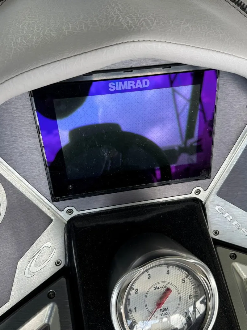 Slide: The Image of Dashboard of 2022 Crest Caribbean RS 250 SLRC with Simrad display and RPM gauge. - 21