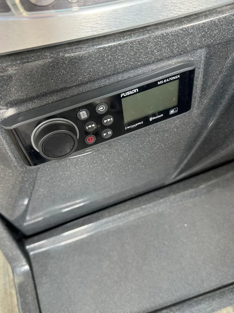 Slide: The Image of Control panel of a 2022 Crest Caribbean RS 250 SLRC boat with Fusion MS-RA70NSX stereo. - 22