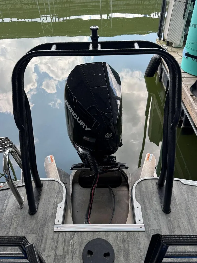 Slide: The Image of 2022 Crest Caribbean RS 250 SLRC boat with Mercury outboard motor on a calm water surface. - 25