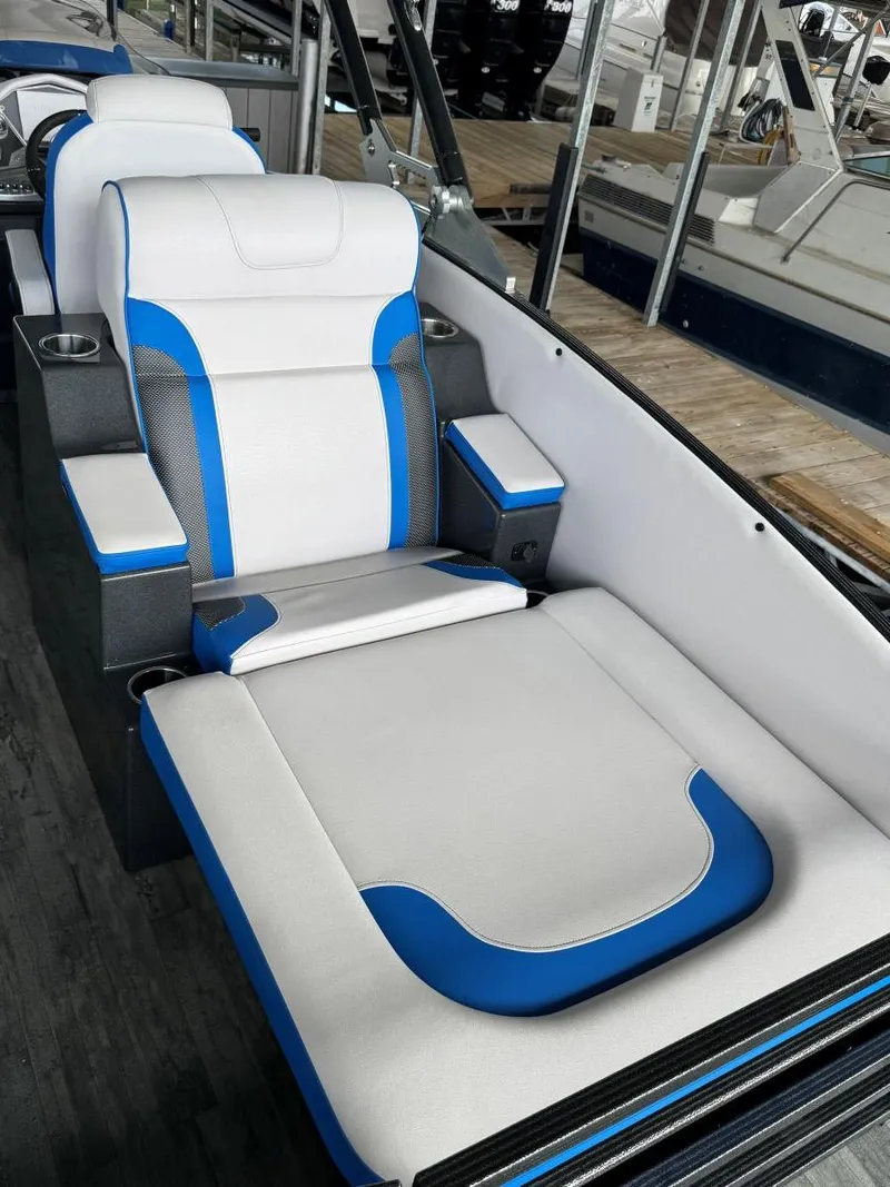 Slide: The Image of 2022 Crest Caribbean RS 250 SLRC boat interior with blue and white seating. - 26