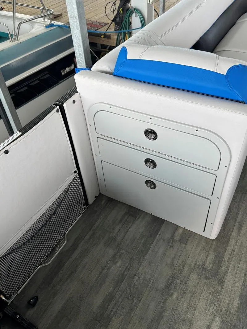Slide: The Image of 2022 Crest Caribbean RS 250 SLRC boat interior with storage drawers and seating. - 32