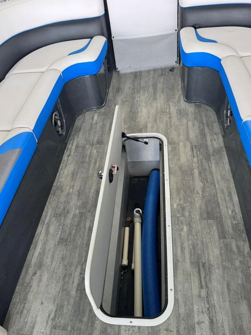 Slide: The Image of 2022 Crest Caribbean RS 250 SLRC boat interior with open storage compartment and seating. - 35