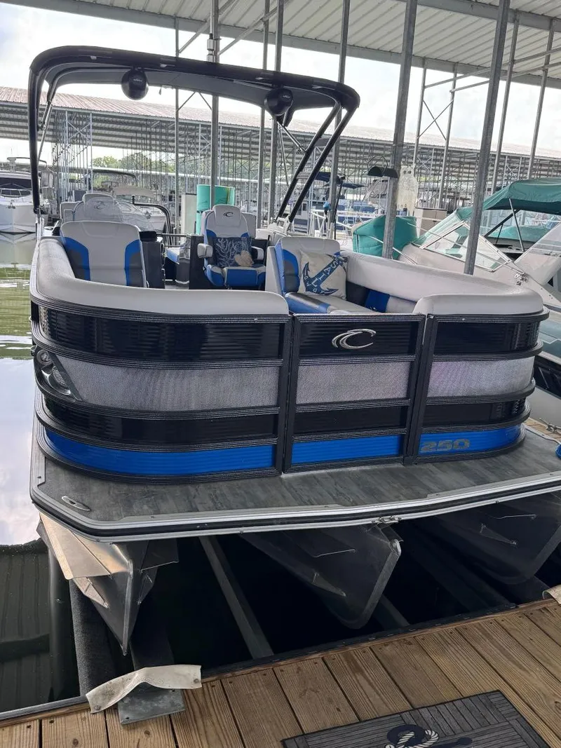 Slide: The Image of 2022 Crest Caribbean RS 250 SLRC pontoon boat docked in a marina. - 7