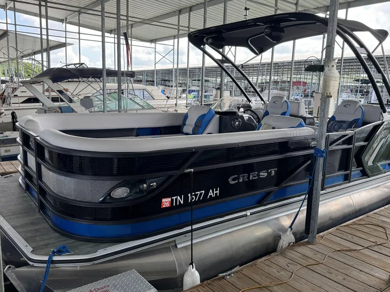 Slide: The Image of 2022 Crest Caribbean RS 250 SLRC pontoon boat docked in a marina. - 8