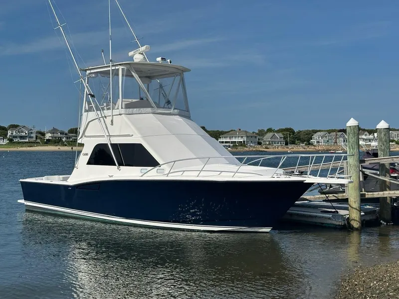 The Image of 2005 Cabo 35 Flybridge yacht docked on a sunny day. - 0