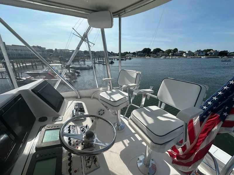 Slide: The Image of 2005 Cabo 35 Flybridge overlooking the harbor. - 13