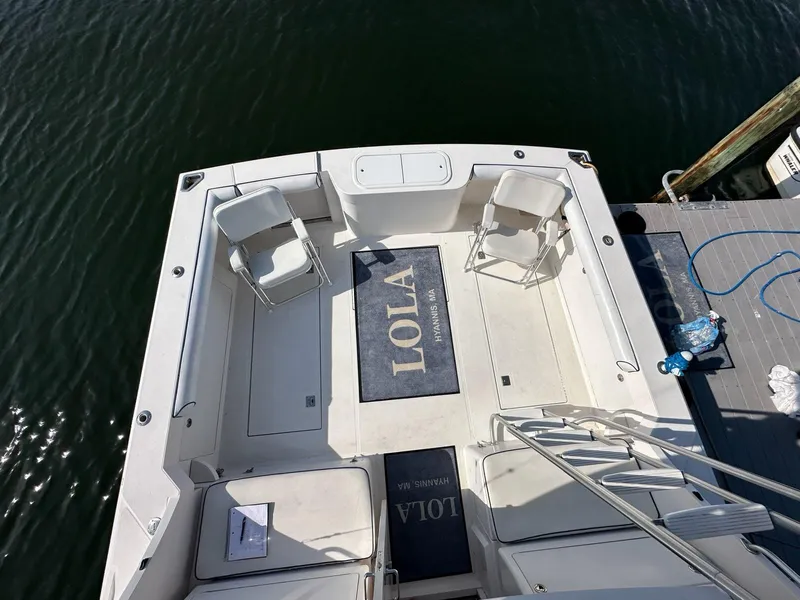 Slide: The Image of Cabo 35 Flybridge 2005 with deck chairs and rug on water. - 14