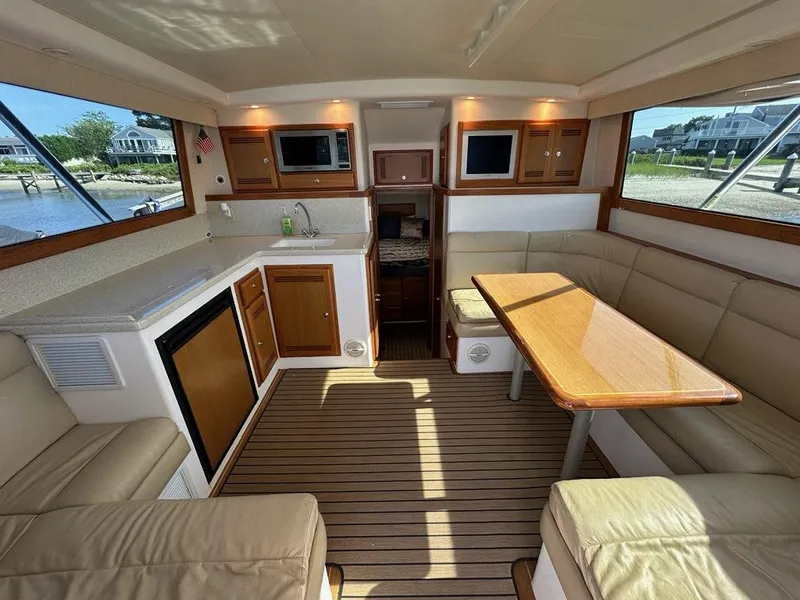 Slide: The Image of Interior of a 2005 Cabo 35 Flybridge yacht with kitchen and seating area. - 15