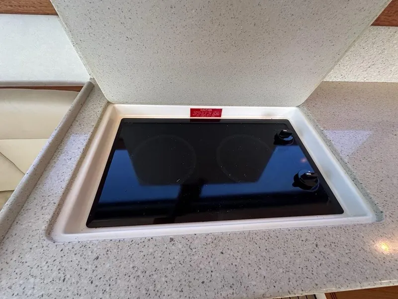 Slide: The Image of Cabo 35 Flybridge 2005 kitchen area with built-in cooktop. - 18