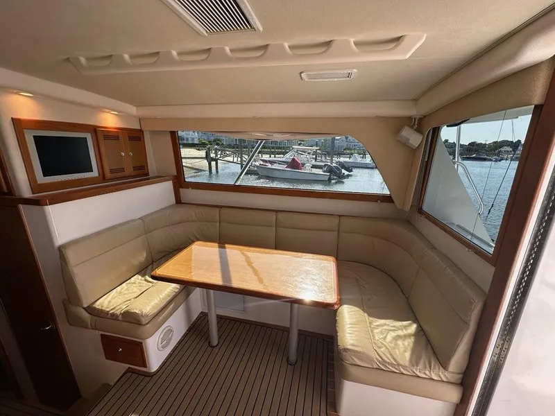 Slide: The Image of Interior of 2005 Cabo 35 Flybridge with seating area and table. - 19
