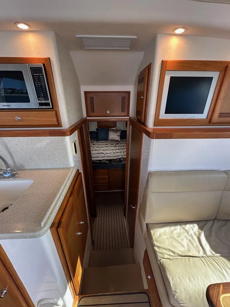 Slide: The Image of Interior of 2005 Cabo 35 Flybridge with kitchen and seating area. - 20
