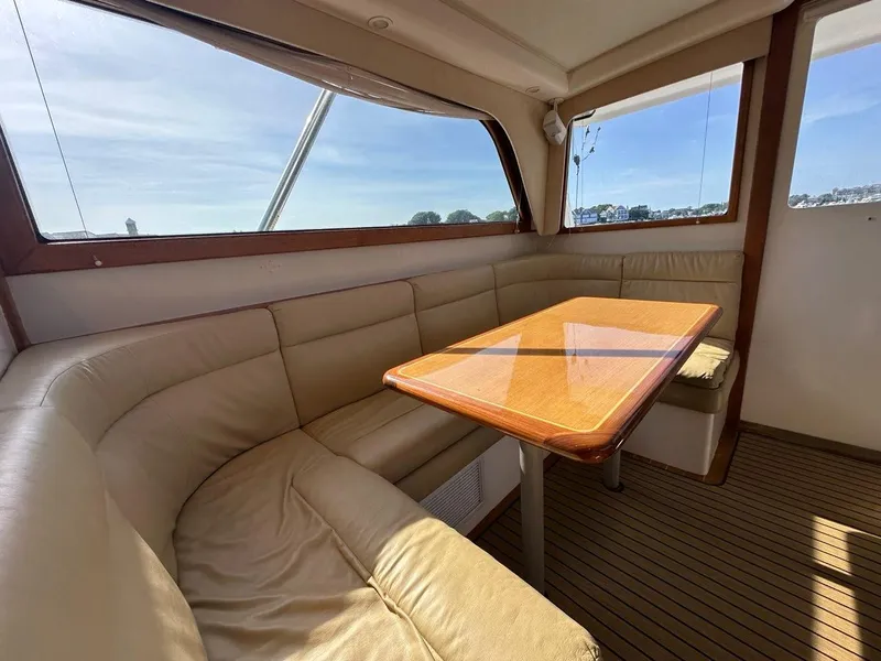 Slide: The Image of Interior of 2005 Cabo 35 Flybridge with leather seating and wooden table. - 21