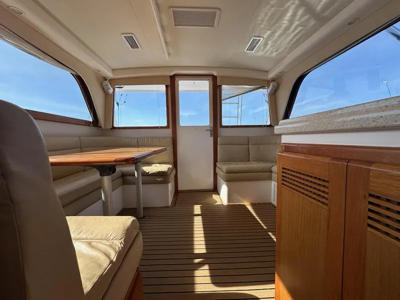 Slide: The Image of Interior of 2005 Cabo 35 Flybridge with wooden floor and leather seating. - 22