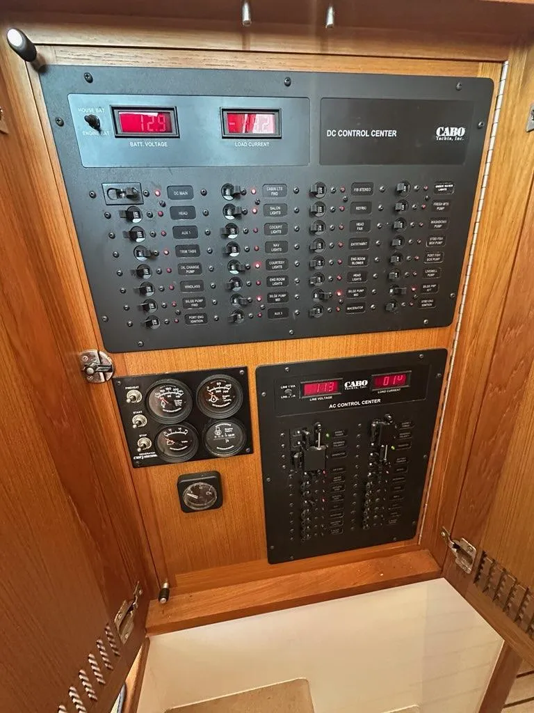 Slide: The Image of Cabo 35 Flybridge 2005 control panel with gauges and switches. - 25