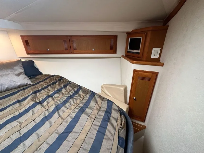 Slide: The Image of Interior of 2005 Cabo 35 Flybridge with bed and storage. - 28