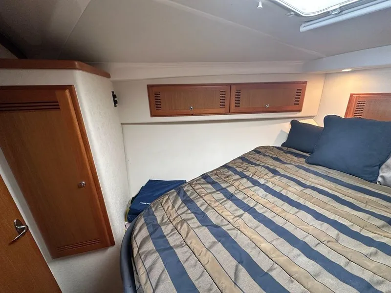 Slide: The Image of Interior of 2005 Cabo 35 Flybridge with bed and cabinets. - 29