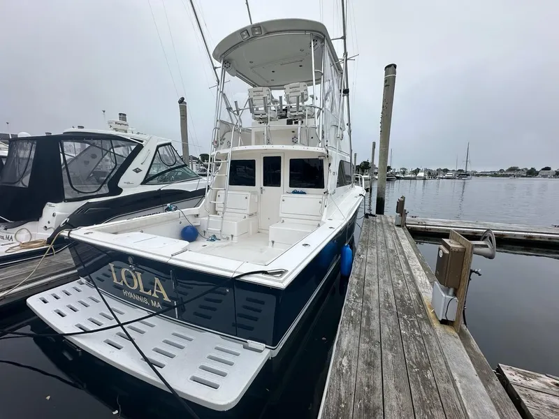 Slide: The Image of 2005 Cabo 35 Flybridge boat docked at marina. - 3