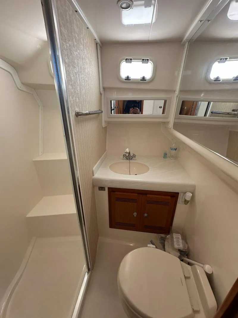 Slide: The Image of Bathroom of 2005 Cabo 35 Flybridge with shower and sink. - 33
