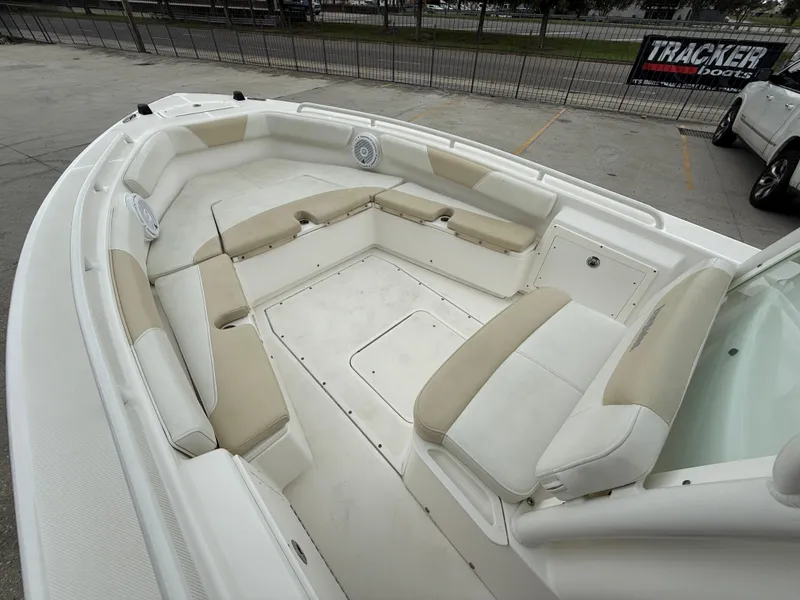 Slide: The Image of 2016 Everglades 243CC boat interior with beige seating and storage compartments. - 10