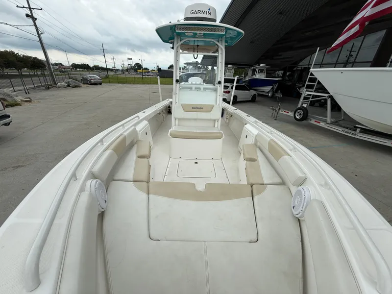 Slide: The Image of 2016 Everglades 243CC boat with spacious seating and Garmin equipment, docked outdoors. - 11