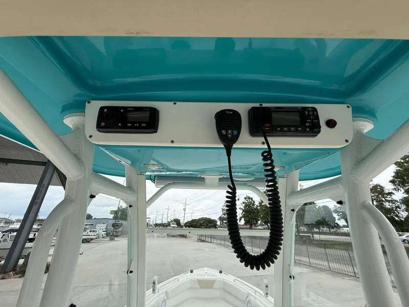 Slide: The Image of 2016 Everglades 243CC boat console with radio and communication equipment. - 16