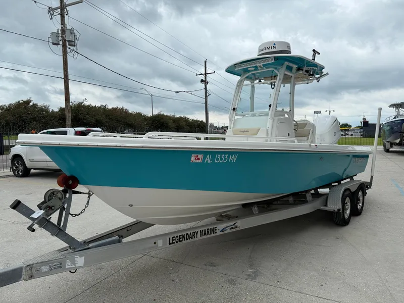 Slide: The Image of 2016 Everglades 243CC boat on trailer, parked outdoors under cloudy sky. - 4
