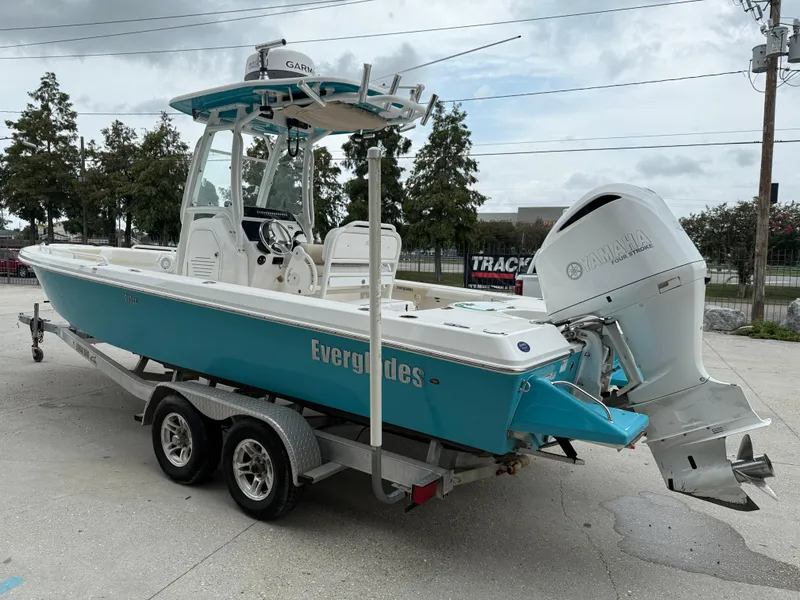 Slide: The Image of 2016 Everglades 243CC boat on trailer with Yamaha engine, parked outdoors. - 5