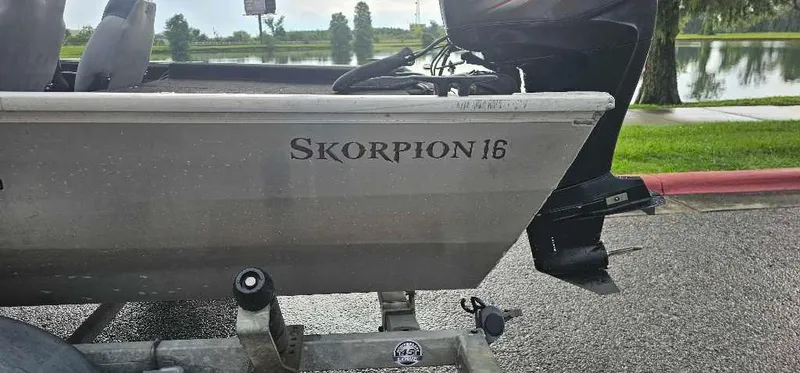 Slide: The Image of 2016 Lowe Stryker 16 boat on trailer by a lake. - 2