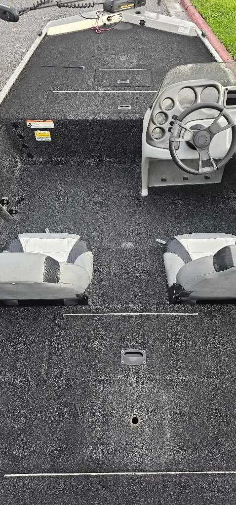 Slide: The Image of 2016 Lowe Stryker 16 boat interior with steering wheel and two seats. - 3