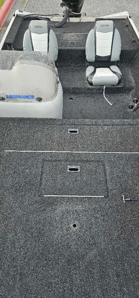 Slide: The Image of 2016 Lowe Stryker 16 boat interior with two seats and carpeted flooring. - 4