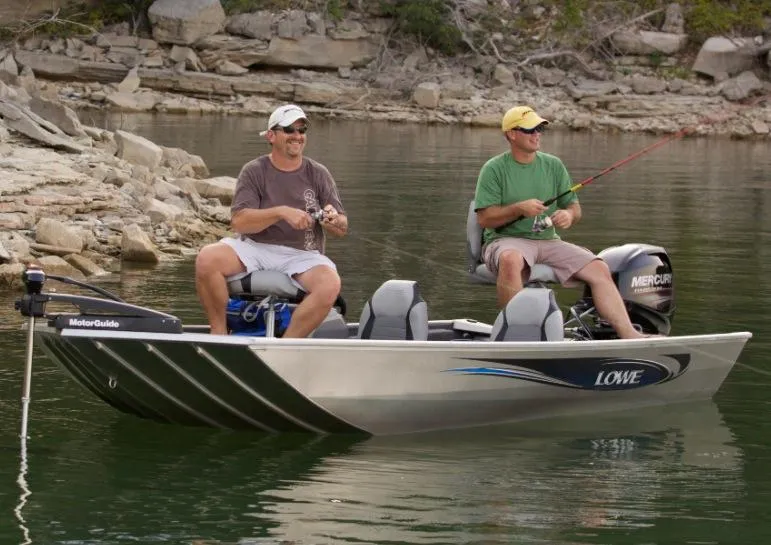 Slide: The Image of Manufacturer Provided Image: Two men fishing on a 2016 Lowe Stryker 16 boat near rocky shore. - 5