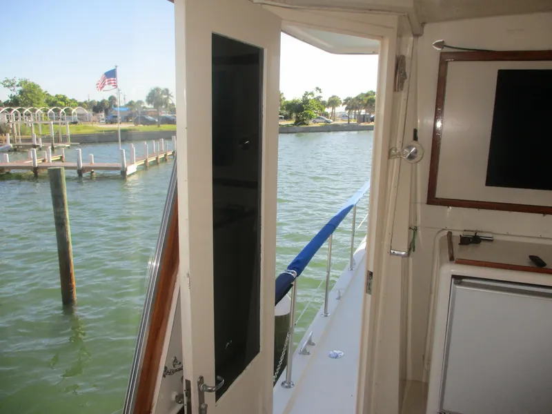 Slide: The Image of Interior view of 1986 Hatteras 43 Double Cabin yacht with open door to water. - 13