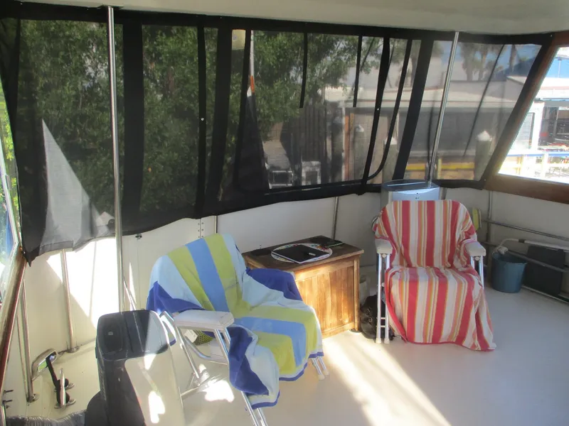 Slide: The Image of 1986 Hatteras 43 Double Cabin interior with chairs and striped towels. - 15