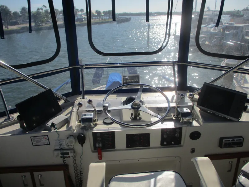 Slide: The Image of 1986 Hatteras 43 Double Cabin helm with steering wheel and navigation equipment. - 17