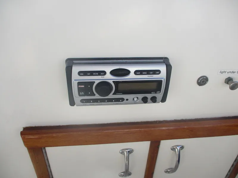Slide: The Image of 1986 Hatteras 43 Double Cabin stereo system with wooden cabinet and control panel. - 19