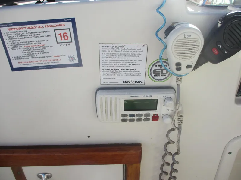 Slide: The Image of VHF radio setup on 1986 Hatteras 43 Double Cabin with emergency call instructions. - 20