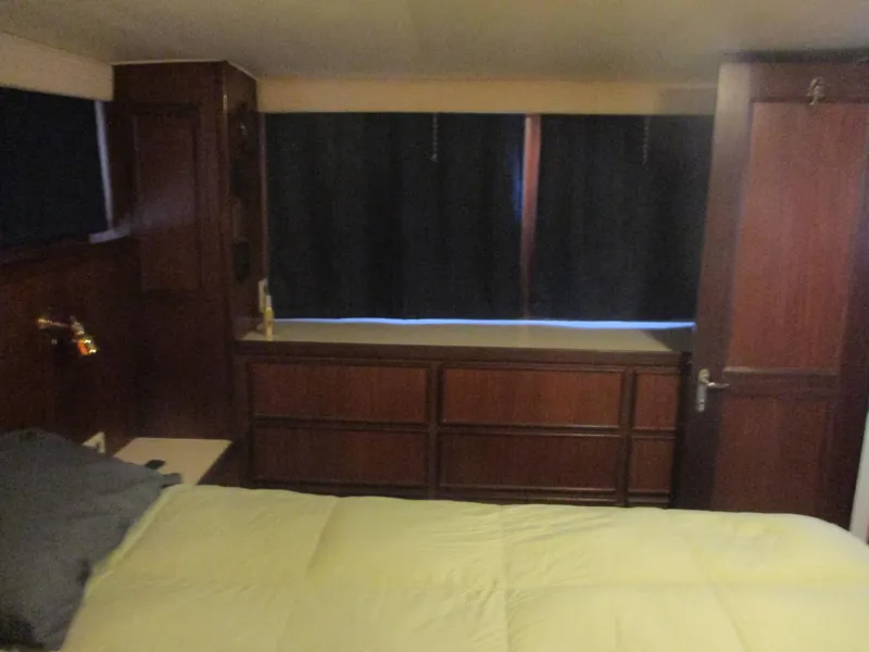 Slide: The Image of Interior of 1986 Hatteras 43 Double Cabin with wood paneling and bed. - 31