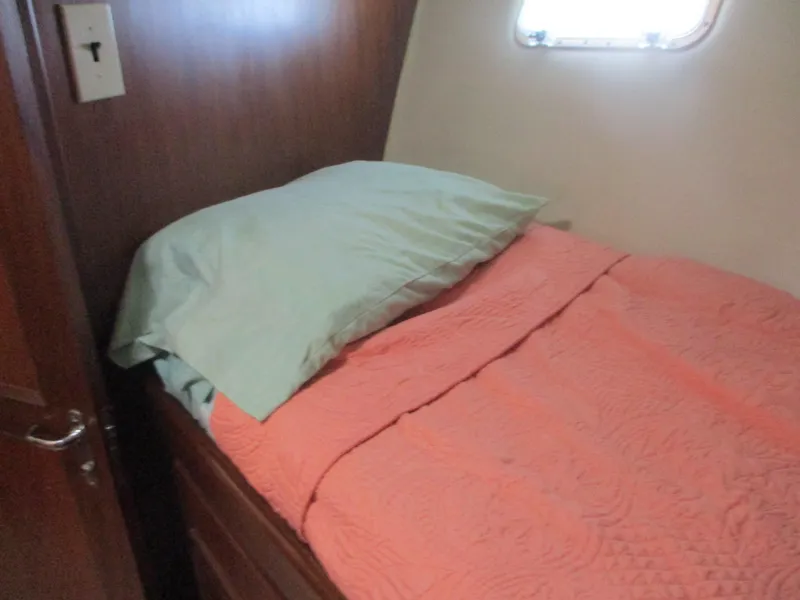 Slide: The Image of Cozy cabin bed in 1986 Hatteras 43 Double Cabin yacht with coral bedding. - 38
