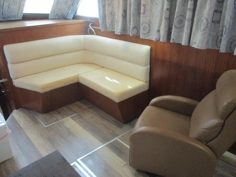 Slide: The Image of Interior of 1986 Hatteras 43 Double Cabin with beige seating and wood paneling. - 42