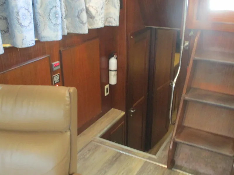 Slide: The Image of Interior of 1986 Hatteras 43 Double Cabin with stairs and wood paneling. - 44