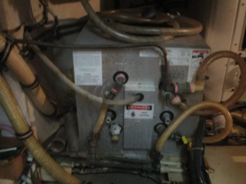 Slide: The Image of Engine room of 1986 Hatteras 43 Double Cabin with various hoses and equipment. - 45