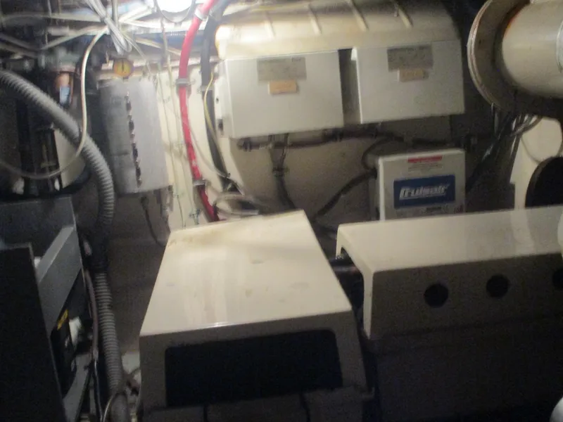 Slide: The Image of Engine room of 1986 Hatteras 43 Double Cabin with visible machinery and wiring. - 46
