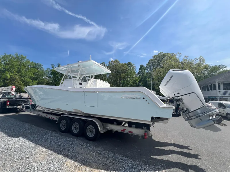Slide: The Image of 2024 Invincible 39 Open Fisherman boat on a trailer under a clear blue sky. - 3