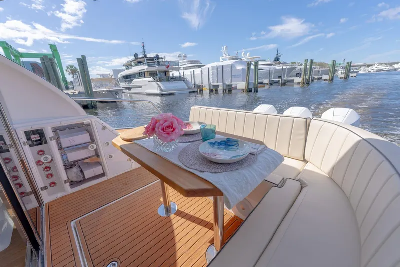 Slide: The Image of Luxurious Hanover 415 yacht interior with elegant dining setup, docked at a marina, 2025 model. - 11