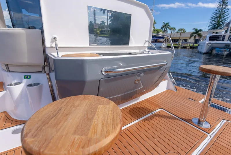 Slide: The Image of Luxury deck of 2025 Hanover 415 yacht with wooden seating and water view. - 14