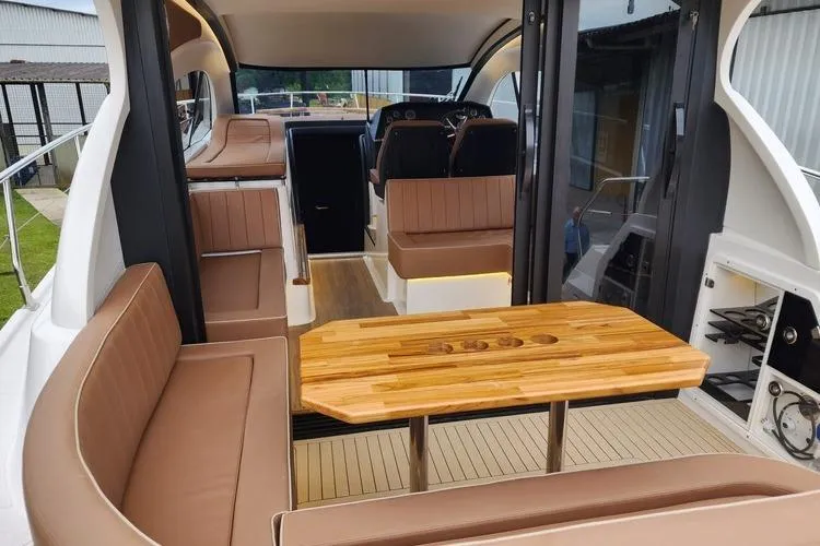 Slide: The Image of Luxurious interior of 2026 Hanover 415 Inboard boat with elegant seating and wooden table. - 17